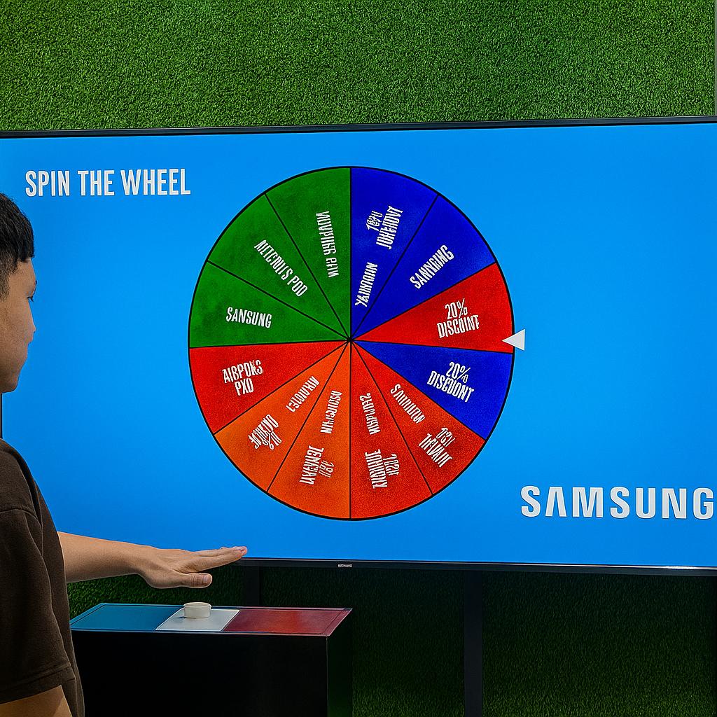 Arab male playing Spin the Wheel game at an exhibition event in Dubai, wearing traditional kandura, fully branded setup with digital screen and prize display, engaging crowd.